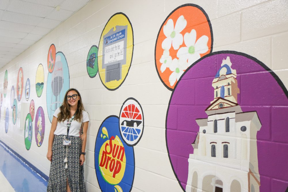 Hannah in front of mural