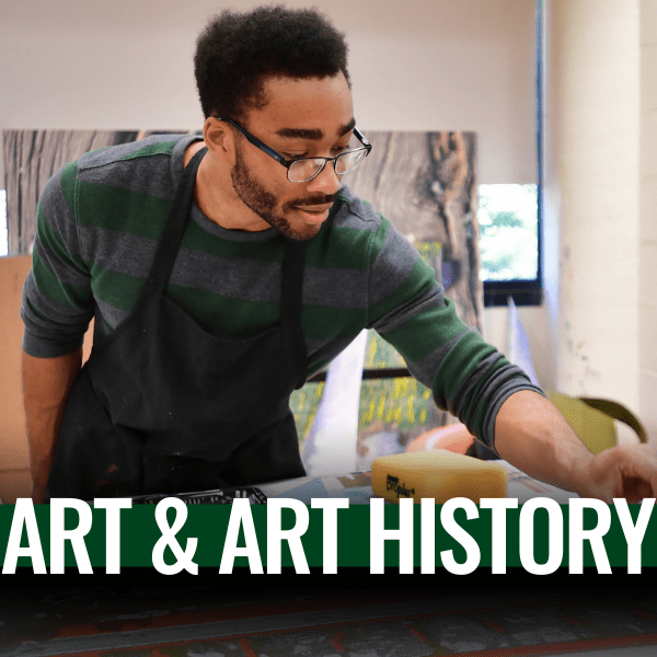 male students painting in a studio