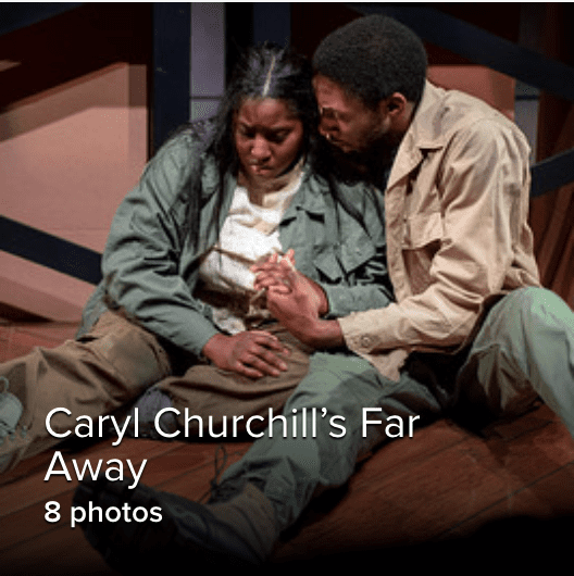 Two students sitting on the floor in war clothes on stage