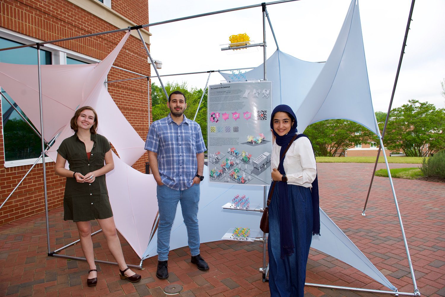 The Container and Contained Installation and three students