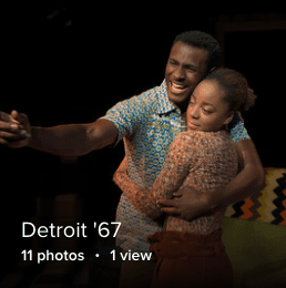 two students hugging and looking into the audience 