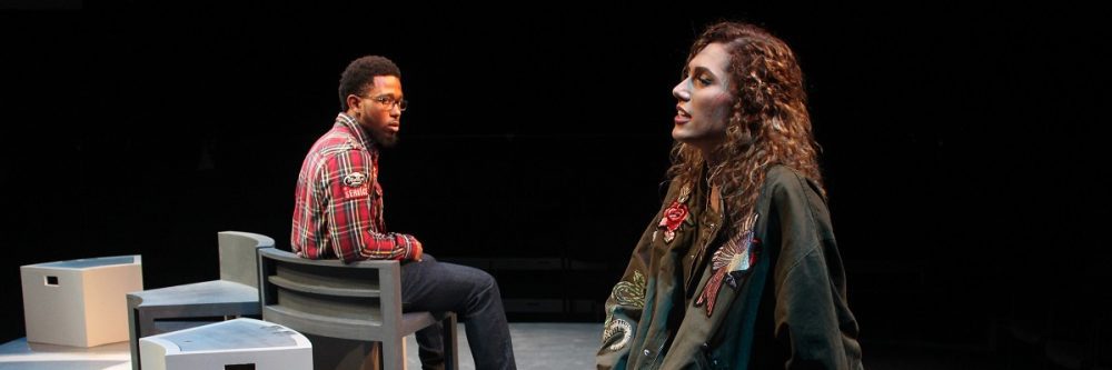 Theatre Scholarships Banner - two students on stage, one in the foreground giving a monologue 