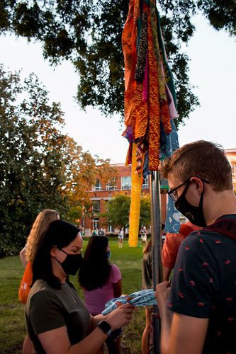 tying ribbons on the pole