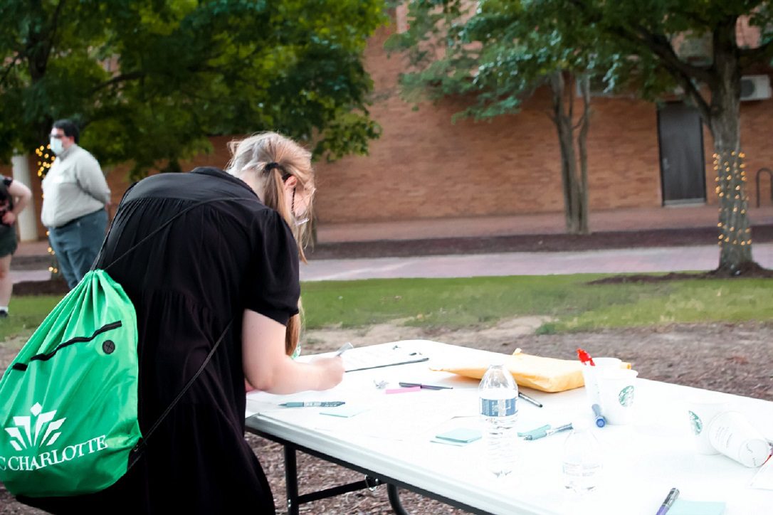 girl writing on a sticky note