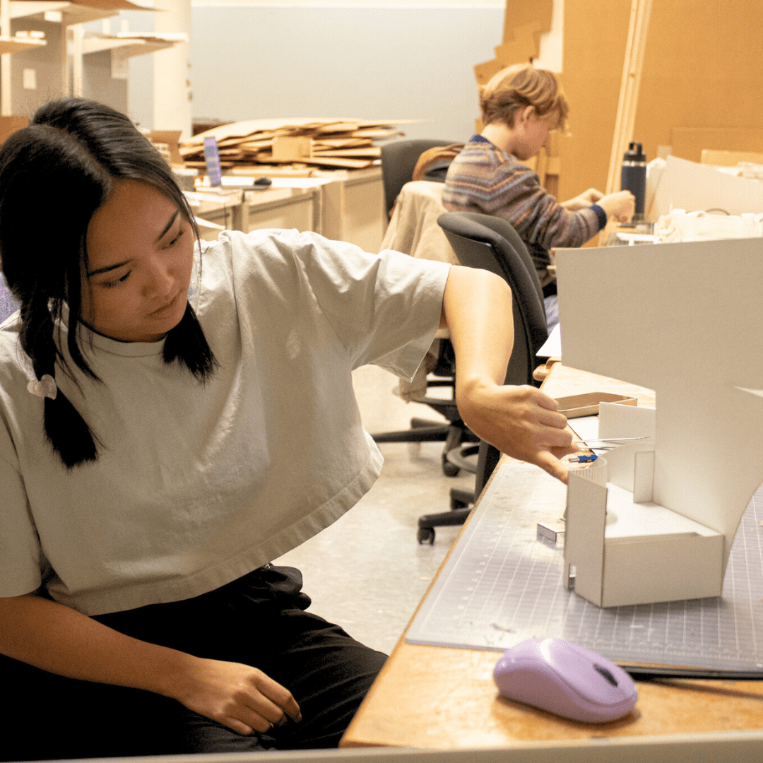 Architecture student working on a model in the studio