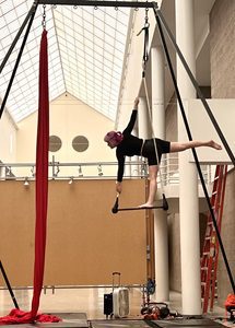 Kiana on a trapeze in circus arts class