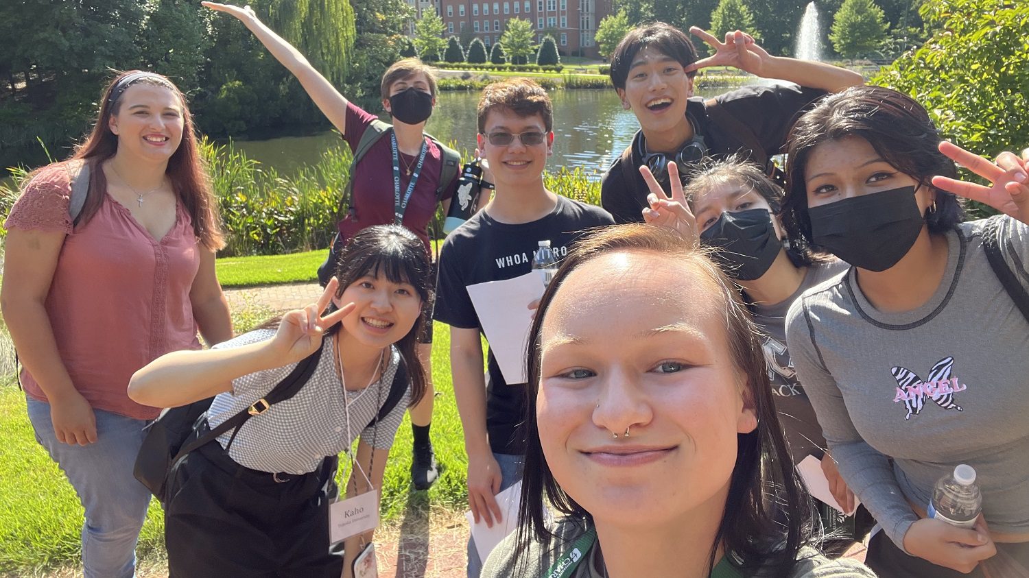 students on campus by the pond and fountain