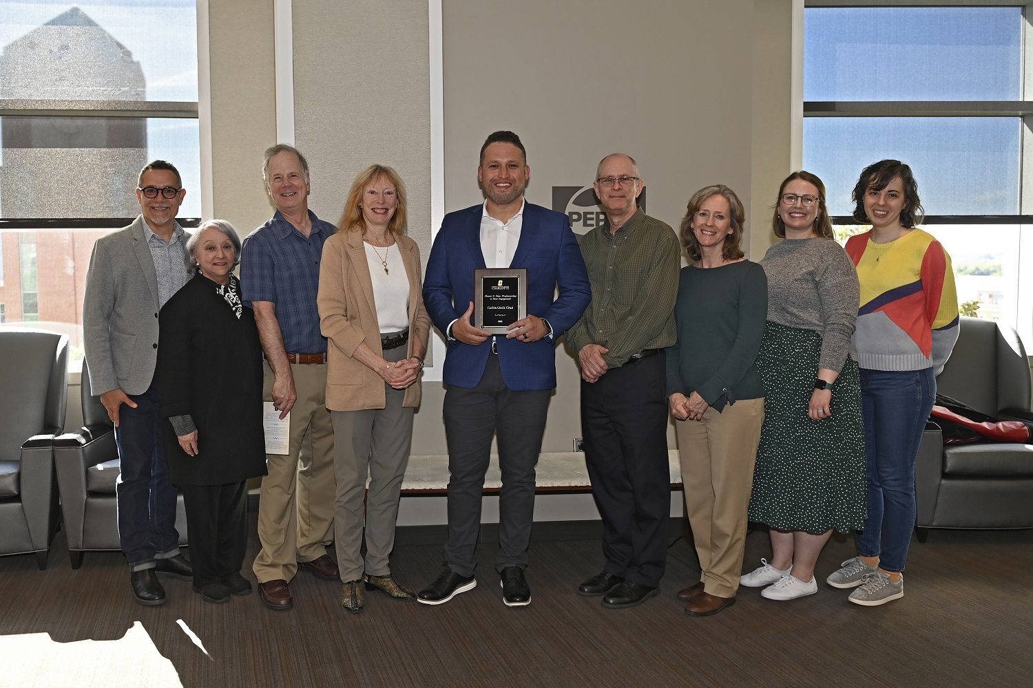 Carlos Cruz at awards ceremony with Provost and members of the College of Ats + Architecture