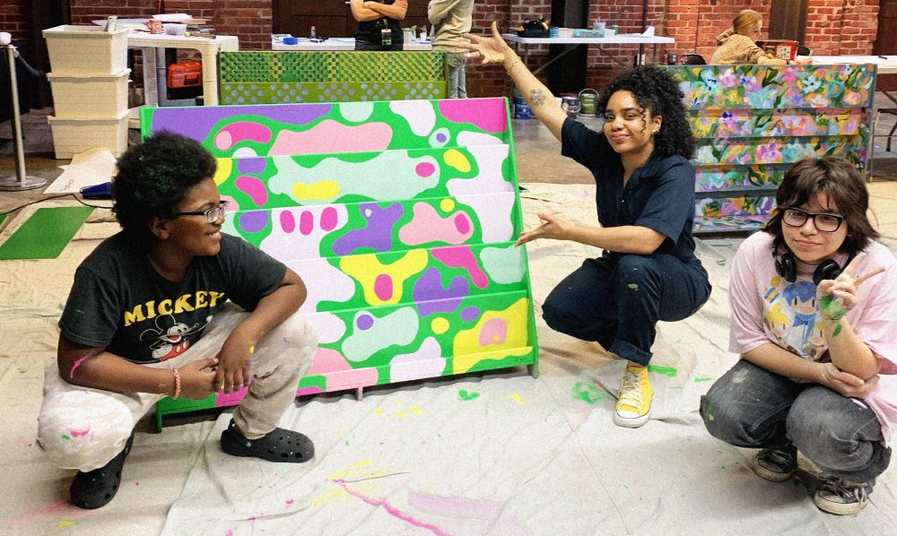 Student posing in front of painting